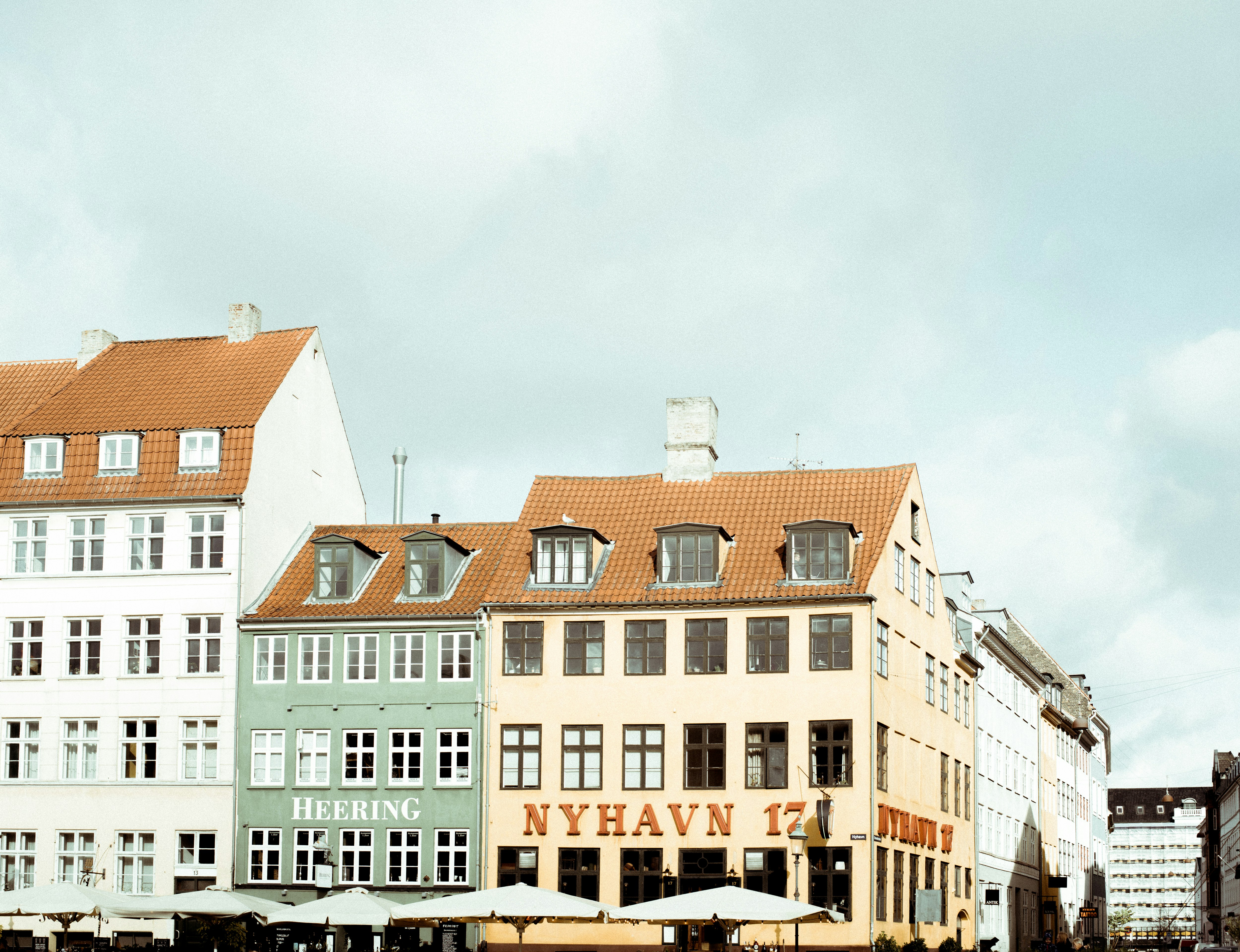 Nyhavn in Copenhagen under white and blue sky during daytime